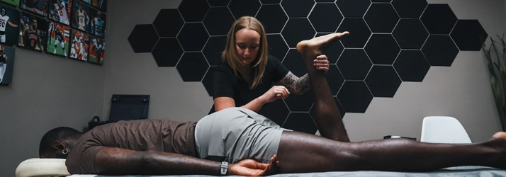 Brittani Wallie massaging a patient.