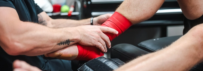 Chiropractic Mayfield Heights OH Sports Injury HERO A person getting their ankle wrapped in red tape.