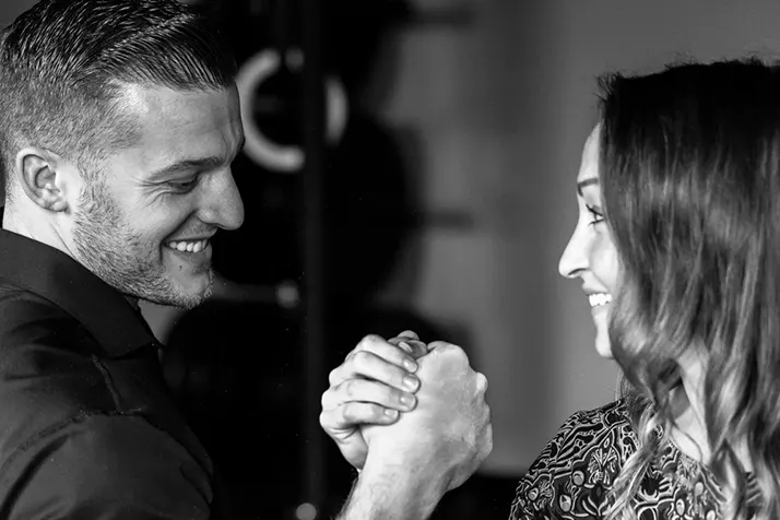 Chad Teague And Mary Teague looking at each other with their hands together.