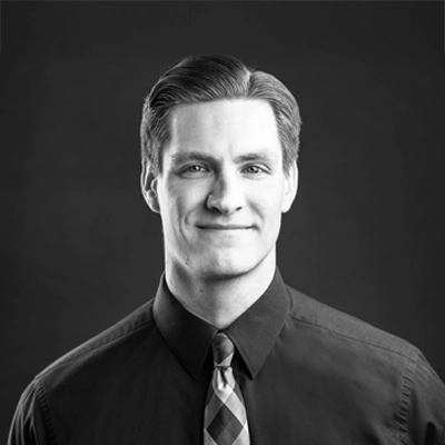Chiropractor Mark Kulinski smiling. The photo is black and white.