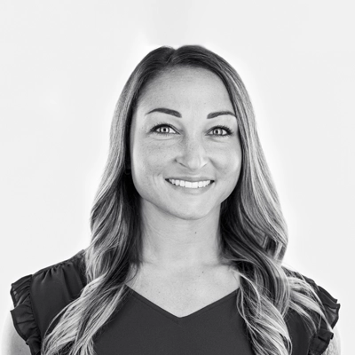 Chiropractor Mary Teague smiling. The photo is black and white.