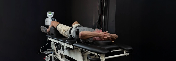 A man on a Mechanical Traction machine.