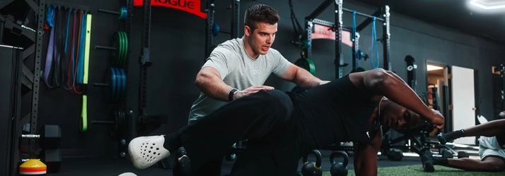 A person being assisted with an exercise.